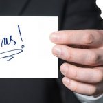 man holding card saying join us